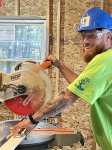 Jason Goggins using a table saw building his Habitat for Humanity house